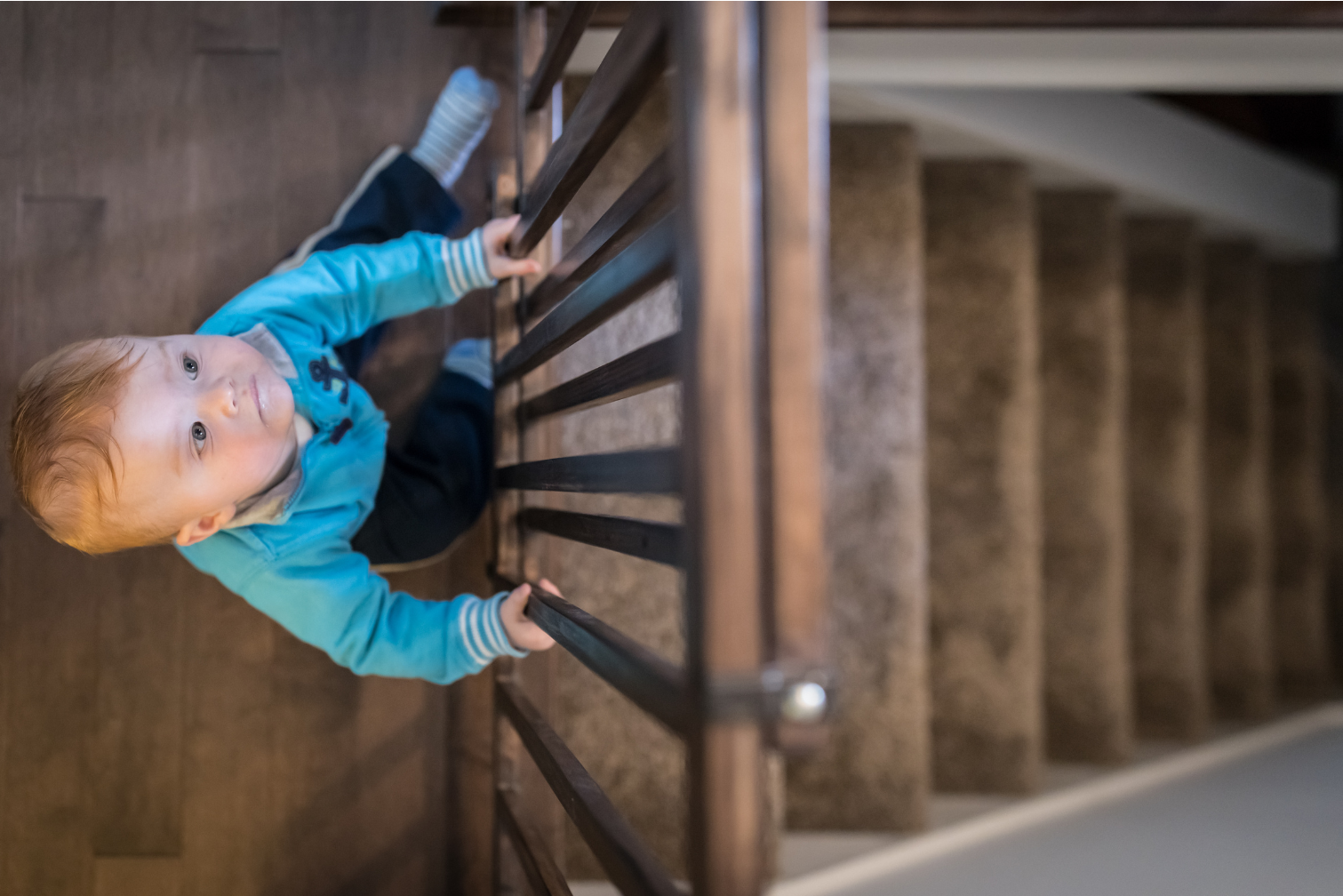 Baby gate installed at top of stairs for child safety