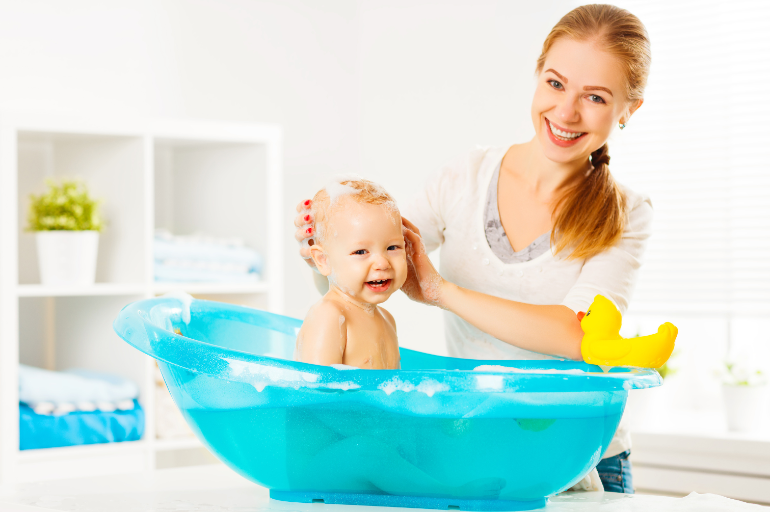 Parent supervising baby in bathtub to ensure water safety